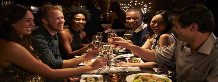 Group Of Friends Enjoying Meal In Restaurant